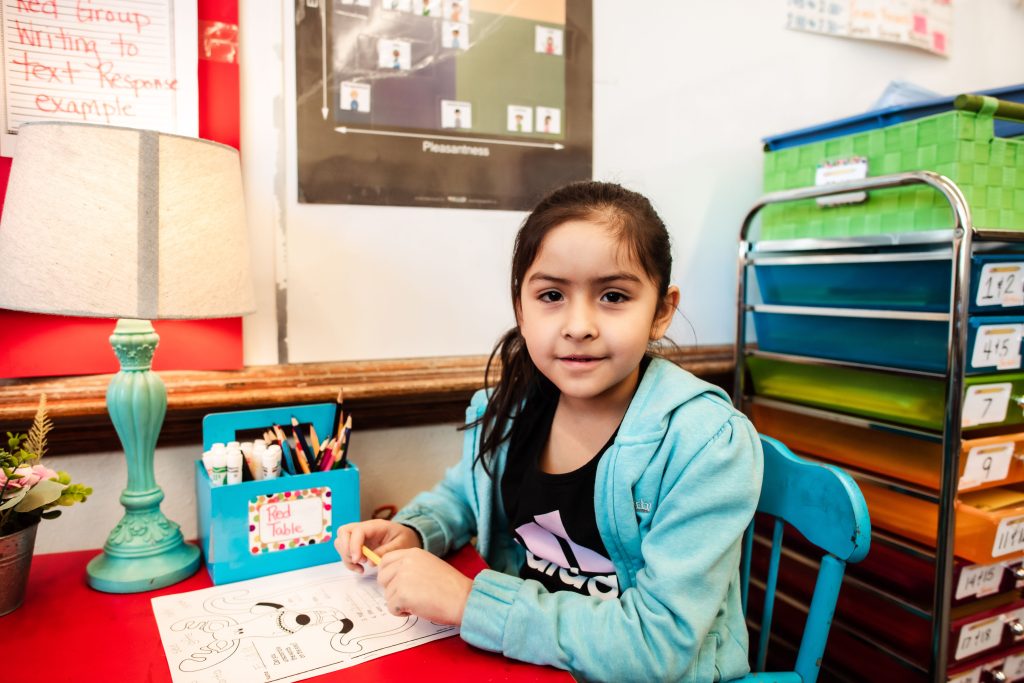 student working and looking at the camera